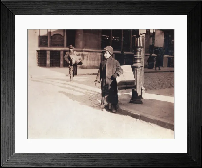 Framed Print : Child labor, ten-year-old child carrying a box of artificial leaves from Leroy Street across Broadway, New York City, photograph by Lewis Wickes Hine, February, 1912