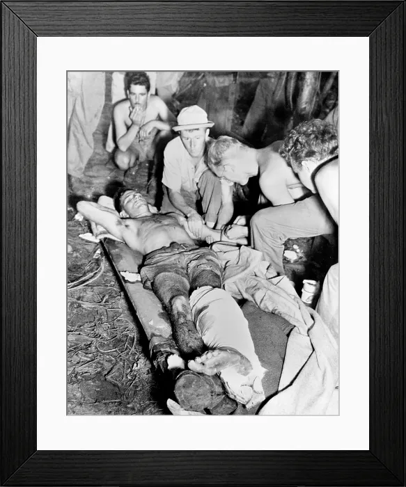 Framed Print : Blood Transfusion. A wounded American soldier gets a blood transfusion while assistants hover about the improvised cot. The scene is 'somewhere in New Guinea', 1943-1945
