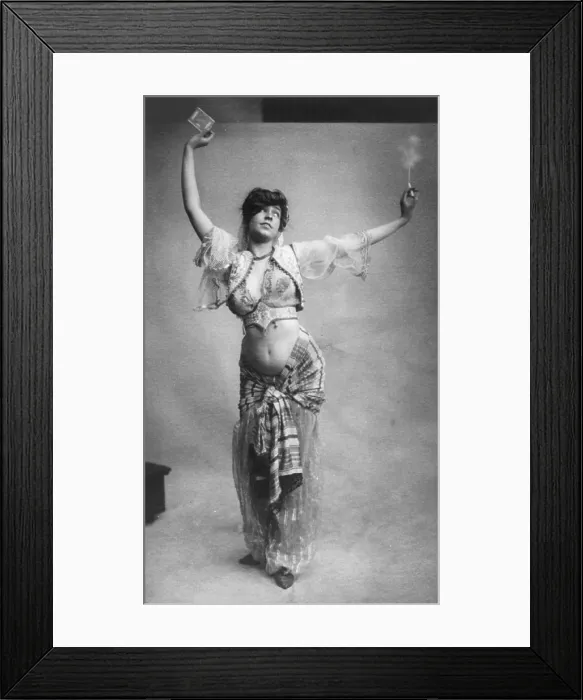 Framed Print : Belly dancing, woman in belly-dancing costume smoking and holding package of cigarettes, photograph, 1900
