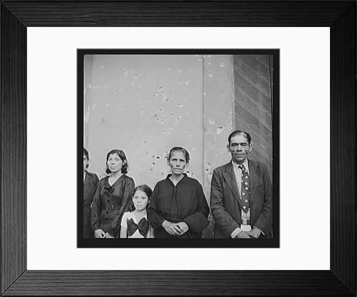 Framed Print : Puerto Rico. Families of Nationalist demonstrators who were killed in the Ponce massacre, standing before the Nationalist headquarters. Note machine gun bullets in wall