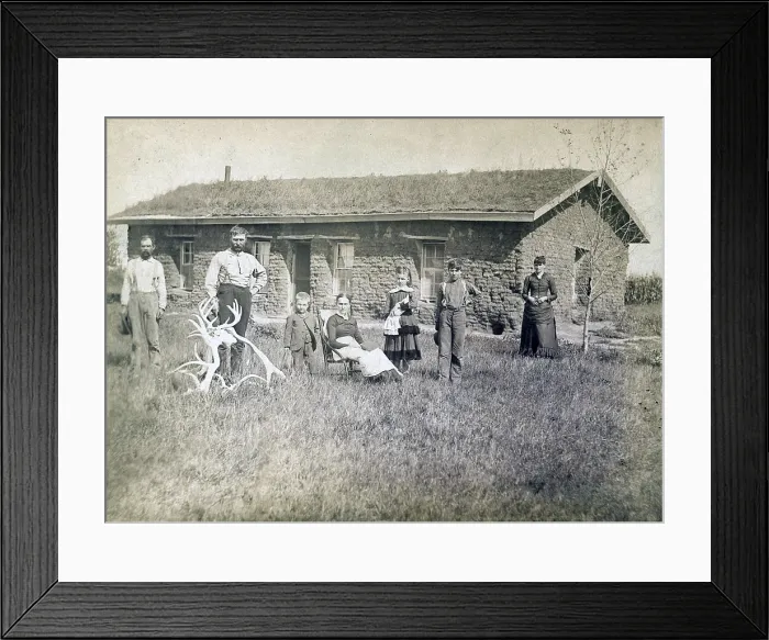 Framed Print : Morrison family in front of sod house in Custer County, Nebraska in 1886. Lumber was scare and sod dwellings were the first home for many pioneers