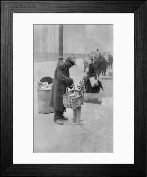 Framed Print : New York City, peddler selling pretzels on sidewalk, East Side food peddler, photograph, February 24, 1917