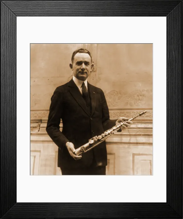 Framed Print : Tomm Brown, one of the six members of the Brown Brothers claimed to have had the first all saxophone act, posed with 1st saxophone made by its inventor, Adolph Sax. 1922