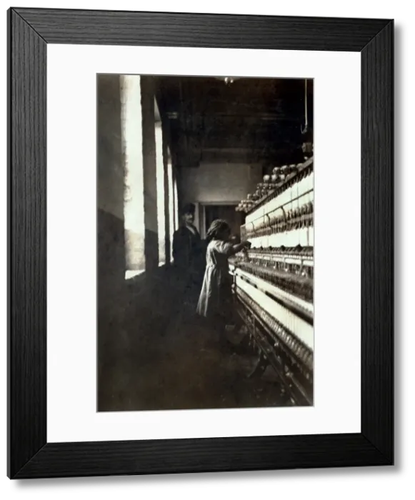 Framed Print : A textile mill. Little girl (48 inches high) work in Amoskeag Mfg. Co. She seemed to be 11 or 12 yrs. old. Manchester, N.H, photograph by Lewis Wickes Hine, May 25, 1909 Framed Print : A textile mill. Little girl (48 inches high) work in Amoskeag Mfg. Co. She seemed to be 11 or 12 yrs. old. Manchester, N.H, photograph by Lewis Wickes Hine, May 25, 1909