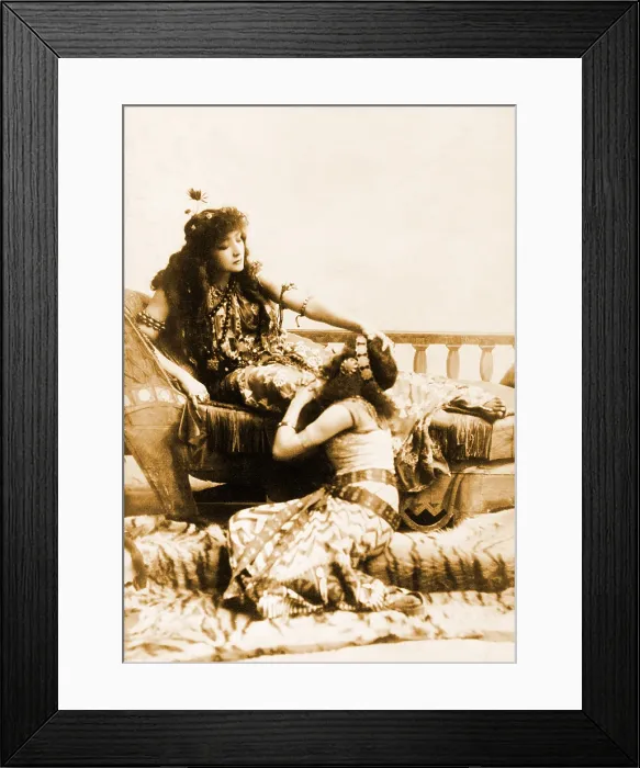 Framed Print : Sarah Bernhardt (1844-1923), French, actress in the role of Cleopatra, reclining with her hand on head of seated woman. Ca. 1891 Framed Print : Sarah Bernhardt (1844-1923), French, actress in the role of Cleopatra, reclining with her hand on head of seated woman. Ca. 1891