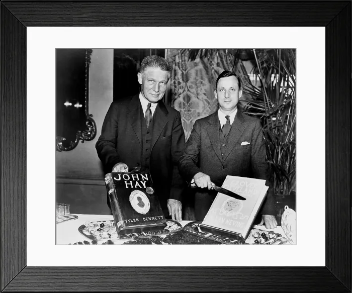 Framed Print : Dr. Allan Nevins (1890-1971) and Tyler Dennett (1883-1949), both historians, celebrate their 1934 Pulitzer Prizes with cakes made to look like each of their books