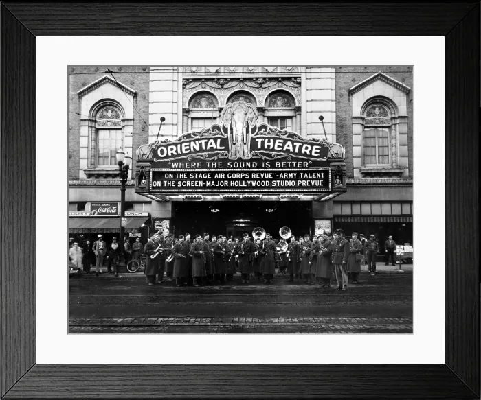 Framed Print : The Oriental Theatre exterior with brass band, marquee reads: Where the Sound is Better