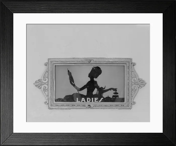 Framed Print : Movie Theaters, restroom door, detail depicting a woman with a mirror, from the Ambler Warner Theater, 108 East Butler Pike, Ambler, Pennsylvania, circa 1930s