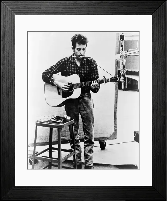 Framed Print : Bob Dylan (b. 1941) playing guitar and harmonica into microphone. 1965