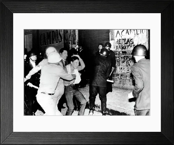 Framed Print : Mexico City: Riot police battle a student demonstrator in a night of violence that ended with Mexican Army troops using bazookas