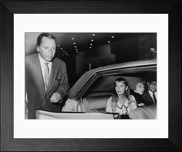 Framed Print : Frank Sinatra (1915-98) and Mia Farrow (b. 1945) prepare to leave the Schubert Theater in New York, in August 1965. The couple were married in July 1966