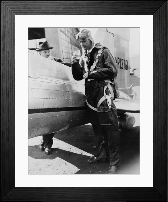Framed Print : Howard Hughes (1905-1976), in flight uniform, as he prepares to board airplane in Newark, N.J. 1946