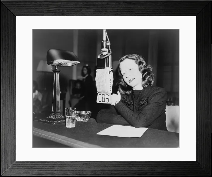 Framed Print : Edna St. Vincent Millay (1892-1950) American poet seated behind CBS microphone speaking on the CHILDREN ARE ALSO PEOPLE program. 1945