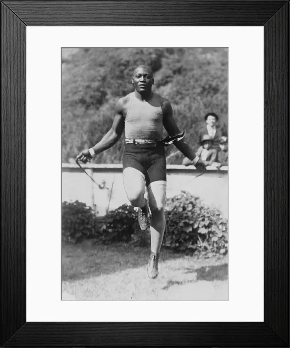 Framed Print : Jack Johnson (1878-1946) Heavyweight Championship of the World, with arms outstretched demonstrating his long reach. 1910. PROBLEM