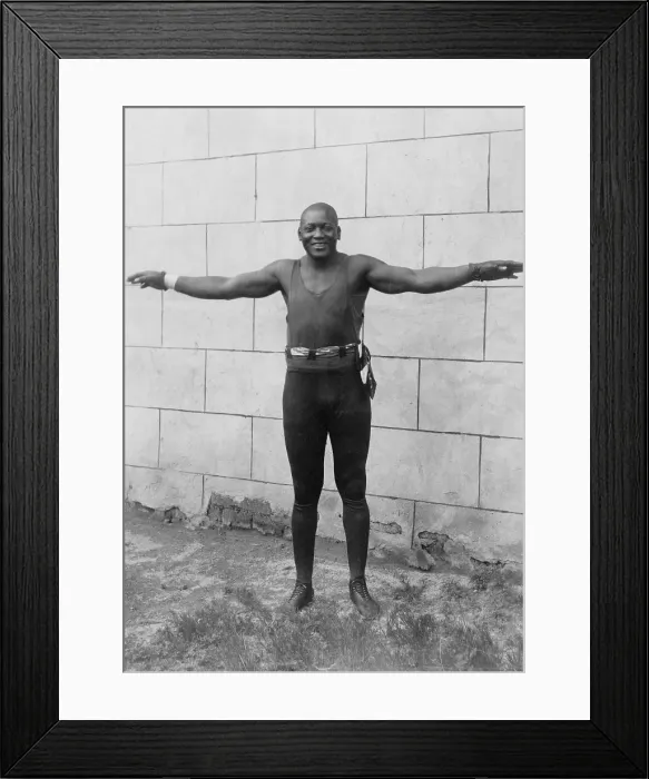 Framed Print : Jack Johnson (1878-1946) Heavyweight Championship of the World, with arms outstretched demonstrating his long reach. 1910. PROBLEM