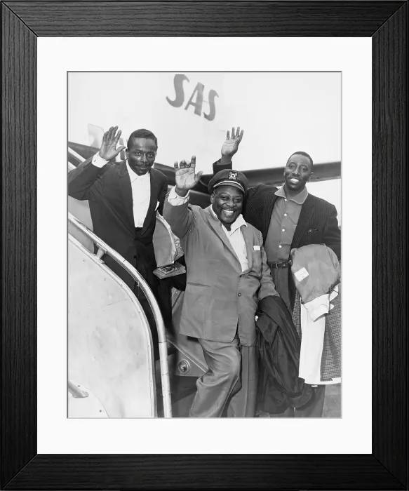 Framed Print : Count Basie (1904-1984) and Count Basie Orchestra members Sonny Payne (left) and Joe Williams (right) wave as they board plane before leaving on European tour in 1956
