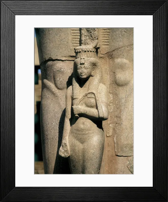 Framed Print : Great Temple of Amon-Re. 16th-4th c. BC. EGYPT. Karnak. Thebes. Temple of Amon - Ra. The Goddess Hathor. Sculpture situated at the feet of a colossal sculpture of Ramses II Framed Print : Great Temple of Amon-Re. 16th-4th c. BC. EGYPT. Karnak. Thebes. Temple of Amon - Ra. The Goddess Hathor. Sculpture situated at the feet of a colossal sculpture of Ramses II