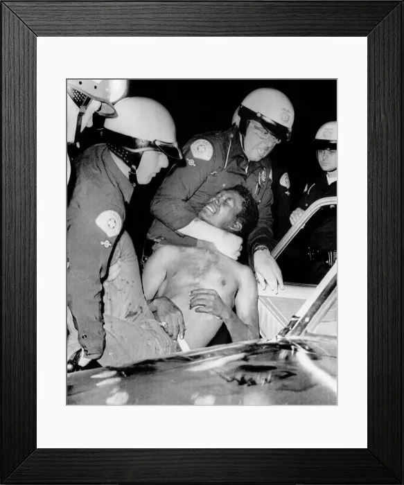 Framed Print : Policemen force a man into a police car during the riots in Watts, 1965. Courtesy: CSU Archives / Everett Collection