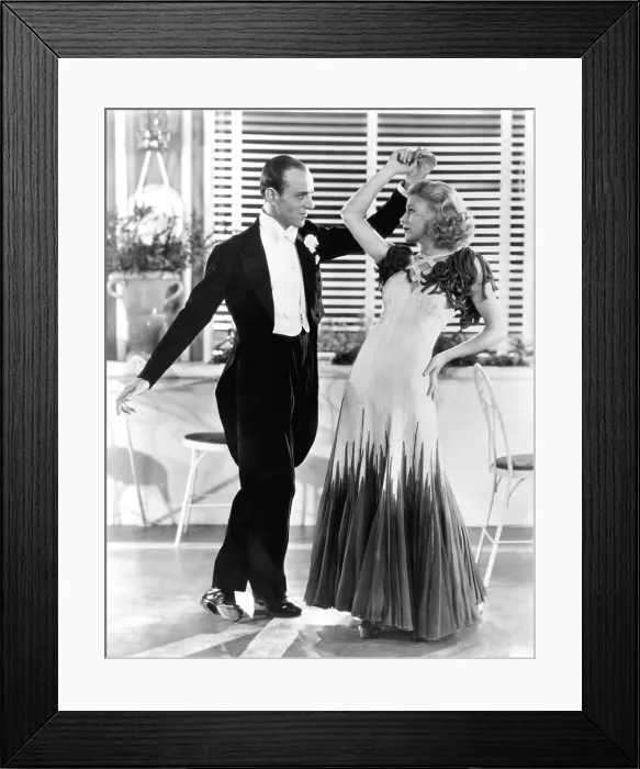 Framed Print : THE GAY DIVORCEE, from left, Fred Astaire, Ginger Rogers, in The Continental number (Rogers in a gown by Walter Plunkett), 1934
