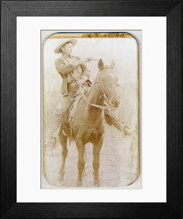 Framed Print : Wild West. Will Roberts, alias Dixon, cowboy train robber, seated on a horse, pointing a gun, 1900