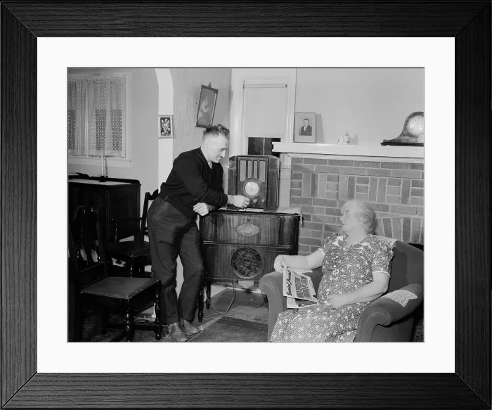 Framed Print : A husband tunes the radio while his wife holds populist right-wing radio priest, Father Coughlin's newspaper SOCIAL JUSTICE, with a headline, STALIN ORDERS WORLD REVOLUTION