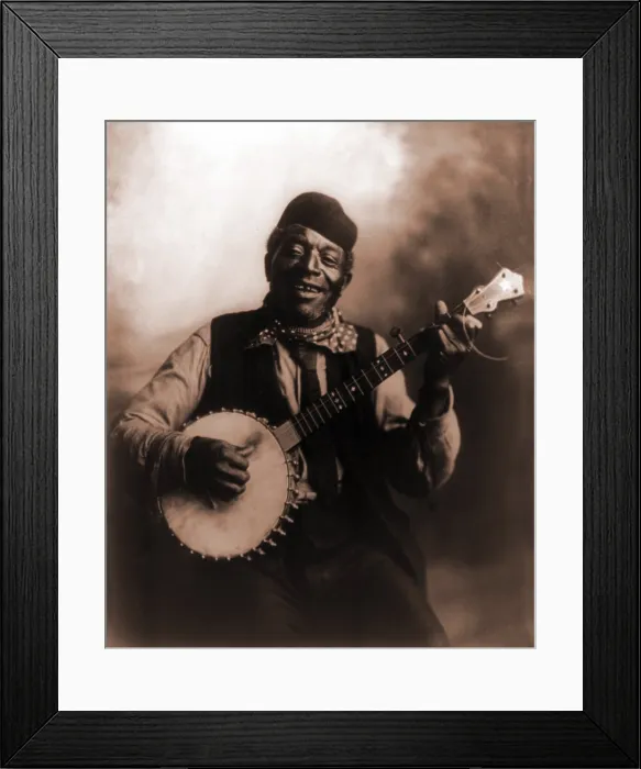 Framed Print : African American man seated and holding banjo. Ca. 1911