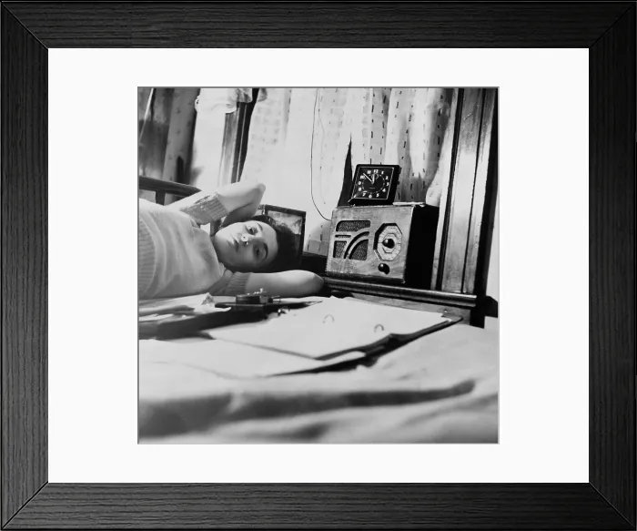 Framed Print : A young women listens to a radio in her Washington D.C. boardinghouse room. 1943 Framed Print : A young women listens to a radio in her Washington D.C. boardinghouse room. 1943