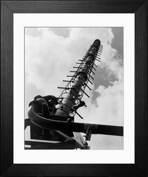Framed Print : Worker climbing a Helical television antenna developed by General Electric engineers in 1951 Framed Print : Worker climbing a Helical television antenna developed by General Electric engineers in 1951