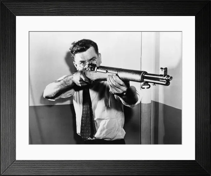 Framed Print : John C. Garand (1888-1974), aiming one of the semi-automatic U.S. rifles, the.30 caliber M 1, he invented. The M1 semiautomatic rifle, was used by U.S Framed Print : John C. Garand (1888-1974), aiming one of the semi-automatic U.S. rifles, the.30 caliber M 1, he invented. The M1 semiautomatic rifle, was used by U.S