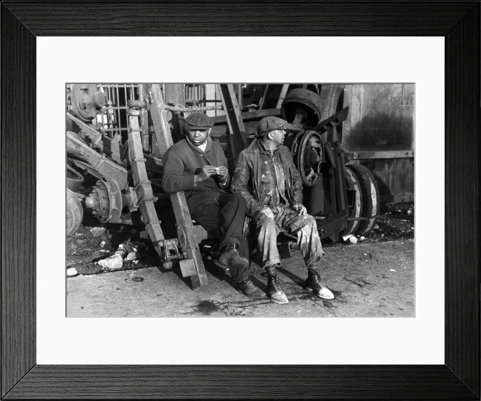 Framed Print : Men sitting on parts of truck in junkyard, South Side of Chicago, Illinois, photograph by Lee Russell, April, 1941