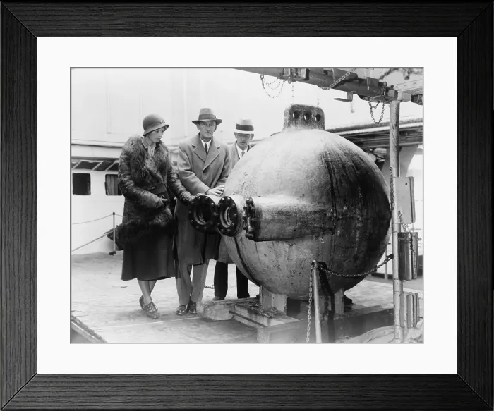 Framed Print : Dr. William Beebe (center) standing with two assistants, next to the bathysphere, a deep-sea submersible lowered into the ocean on a cable