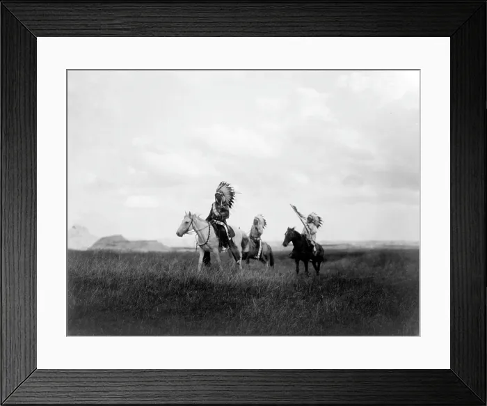 Framed Print : The March of the Sioux, three Sioux Indians on horseback on plains with rock formations in background, photograph by Edward S. Curtis, 1905
