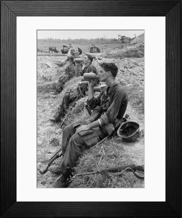 Framed Print : Vietnam War. Soldiers of the 25th Infantry Division drink from their canteens during a break in their patrol operations in Duc Pho, Vietnam. Aug. 31, 1967