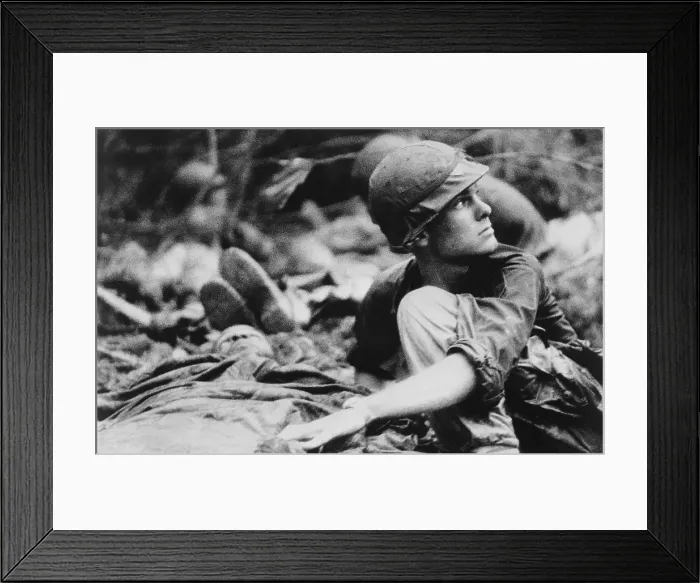 Framed Print : Vietnam War. Army medic searches the sky for a Medevac helicopter to evacuate wound soldiers, during search and destroy in the southeastern region of the South Vietnam. June 1967