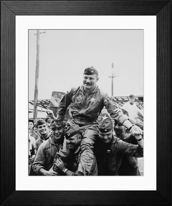 Framed Print : Vietnam War. Colonel Robin Olds (1922-2007) and pilots celebrate the completion his 100th combat mission