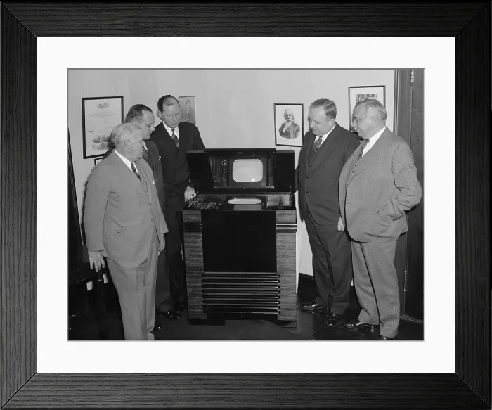 Framed Print : FCC Commissioners inspect latest television in 1939. The TV had a small screen incased horizontally in a large wooden cabinet and was viewed from a reflective mirror