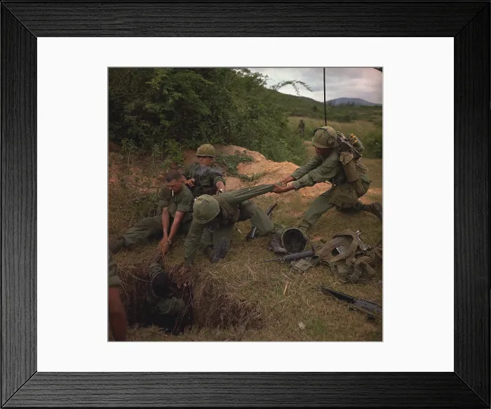 Framed Print : Vietnam War. A US infantryman is lowered into a tunnel by members of the reconnaissance platoon during Operation Oregon