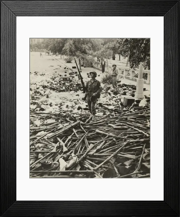 Framed Print : American M.P. standing on a large pile of Italian weapons on a street in Palermo, Italy, on August 6, 1943 Framed Print : American M.P. standing on a large pile of Italian weapons on a street in Palermo, Italy, on August 6, 1943