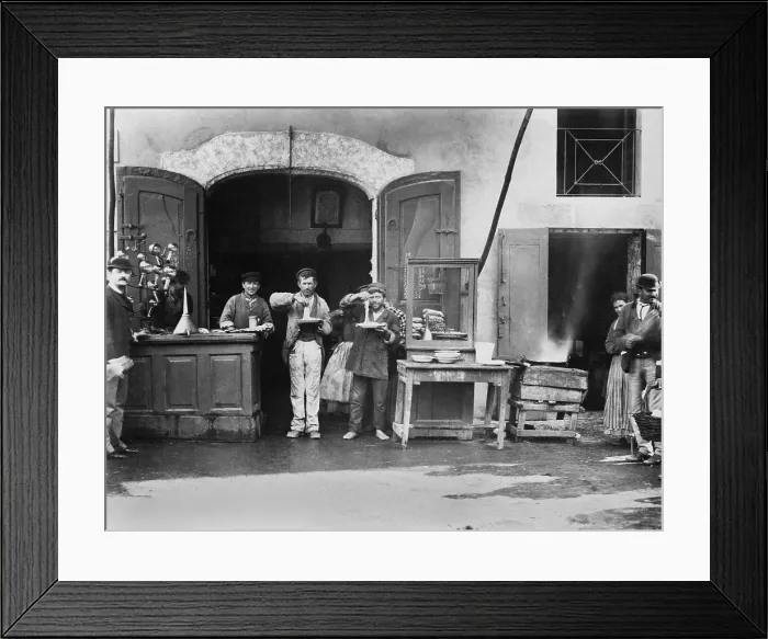Framed Print : Two men with plates of long spaghetti eat at a street eatery in Naples, Italy. Ca. 1900
