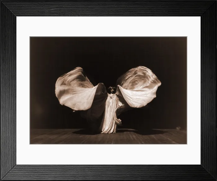 Framed Print : Loie Fuller, (1862-1928), raising her very long gown in shape of butterfly. She used her over-sized costumes to extend her dance effects. 1902