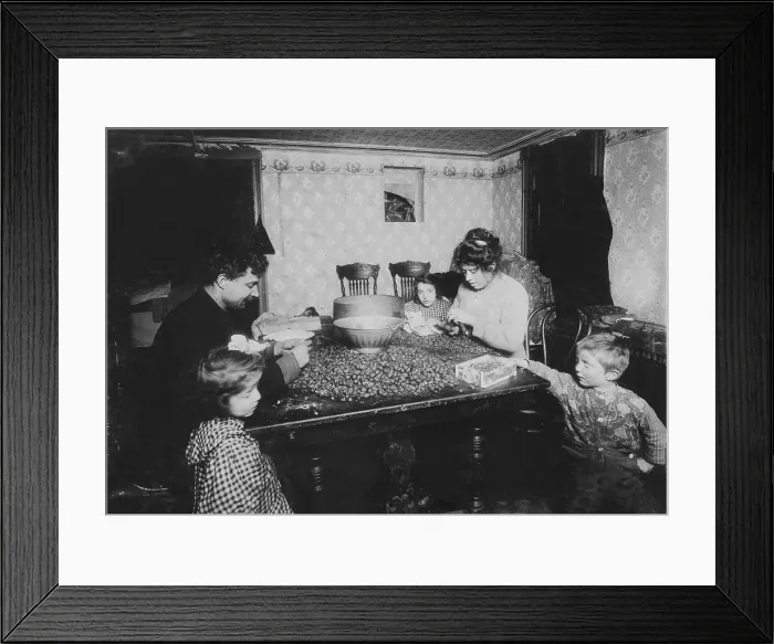 Framed Print : Working family, caption: Picking nuts in dirty basement, dirtiest imaginable children were pawing over nuts, eating lunch on the table, mother had a cold Framed Print : Working family, caption: Picking nuts in dirty basement, dirtiest imaginable children were pawing over nuts, eating lunch on the table, mother had a cold