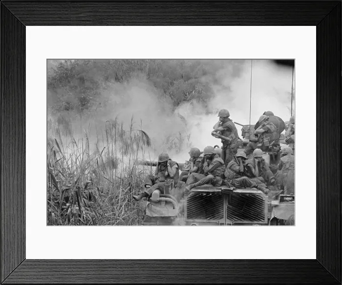 Framed Print : Vietnam War. Marines riding atop an M-48 tank cover their ears as the 90mm gun fires southwest of Phu Bai. April 5, 1968