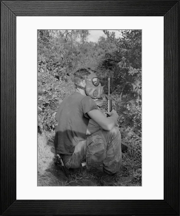 Framed Print : Vietnam War. US Marine wearing gas mask while waiting to enter a Viet Cong tunnel 22 miles south of DaNang, Vietnam. 1968