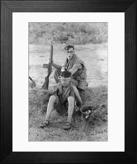 Framed Print : Vietnam War. A US Marine corporal guards an bound, blindfolded, North Vietnamese soldier he captured ten miles northeast of An Hoa, Quang Nam Province, South Vietnam. Nov Framed Print : Vietnam War. A US Marine corporal guards an bound, blindfolded, North Vietnamese soldier he captured ten miles northeast of An Hoa, Quang Nam Province, South Vietnam. Nov