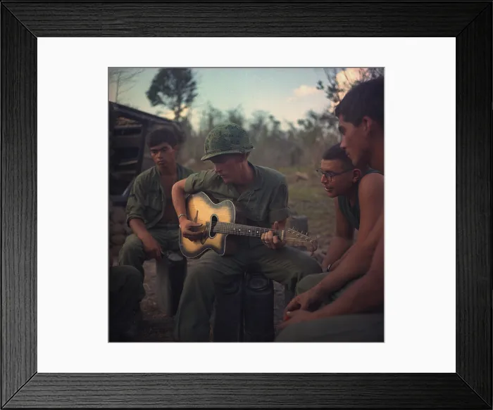 Framed Print : Vietnam War. US Army infantrymen gather around a guitar player and sing a few songs after a hard day during Operation Yellowstone. The operation ran from Dec. 7, 1967 through Feb