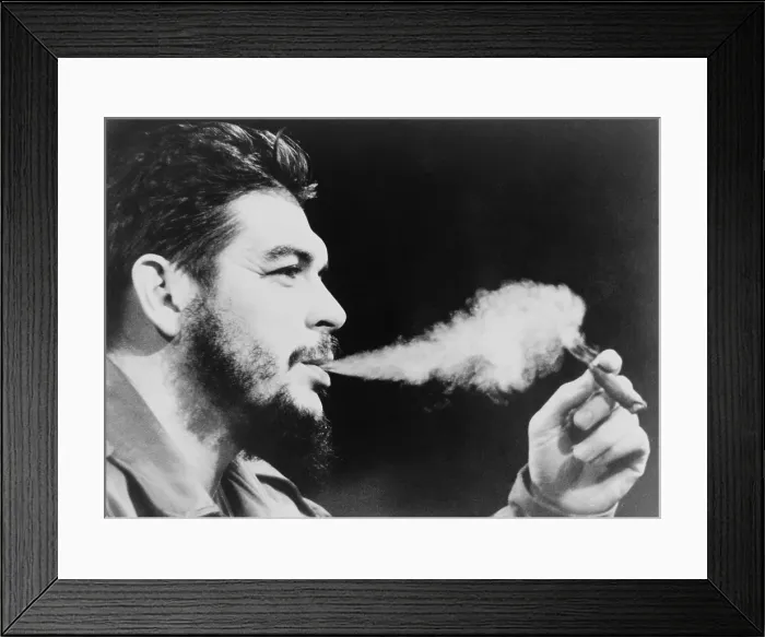 Framed Print : Ernesto Che Guevara (1928-1967), exhaling plume of cigar smoke. 1964 photo taken in New York City
