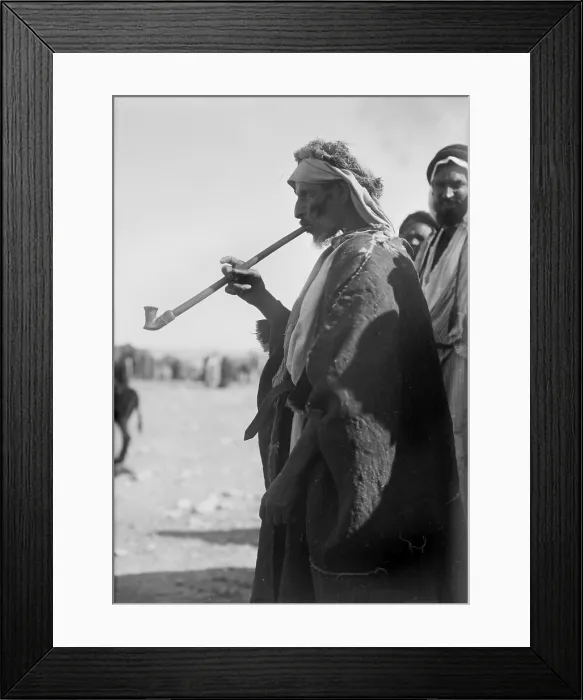 Framed Print : Bedouin man smoking a long pipe. photograph 1920