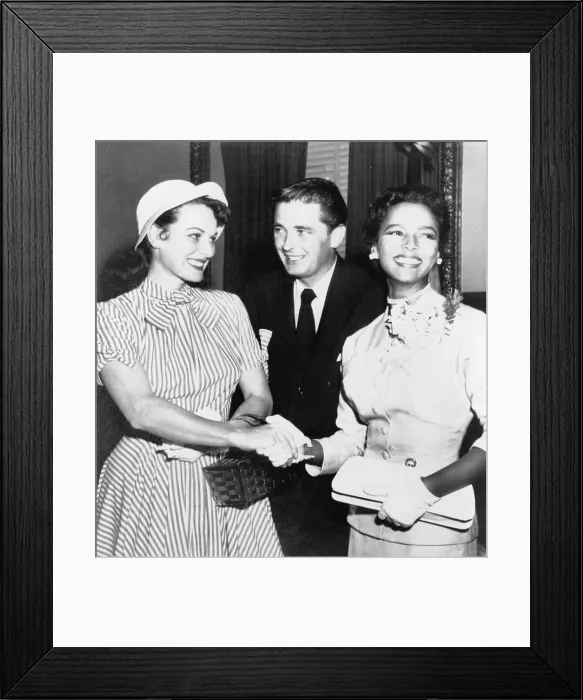 Framed Print : Maureen O'Hara and Dorothy Dandridge (1922-1965) join hands, outside courtroom, as if to seal a pact against Confidential Magazine, while Maureen's brother Framed Print : Maureen O'Hara and Dorothy Dandridge (1922-1965) join hands, outside courtroom, as if to seal a pact against Confidential Magazine, while Maureen's brother