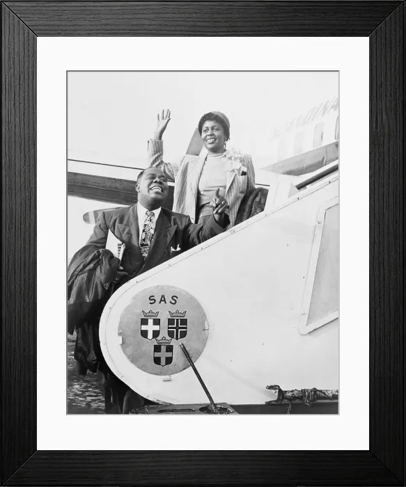 Framed Print : Louis Armstrong (1901-1971), African American Jazz musician, and his wife Lucille boarding airplane for Stockholm. 1952