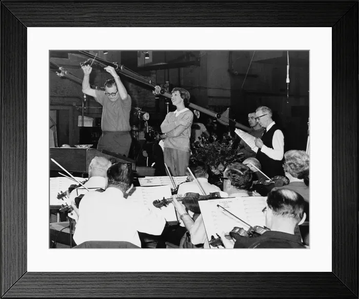 Framed Print : Julie Andrews singing with an orchestra in a recording studio for sound track of film, THE SOUND OF MUSIC (1964)